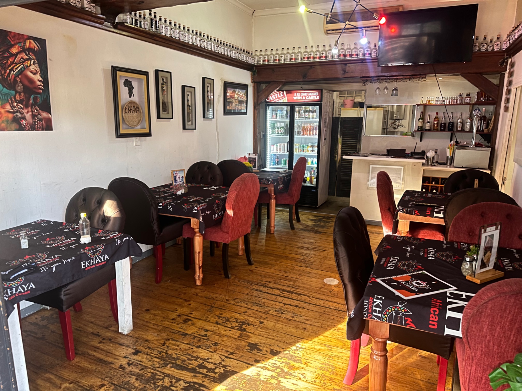 Ekhaya restaurant interior with seating, bar and Ekhaya branded tablecloths
