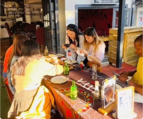 Friends sharing food inside the Ekhaya restaurant