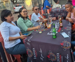 Guests enjoying a sunny afternoon at an Ekhaya table