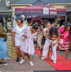Guests dancing on the red carpet outside Ekhaya