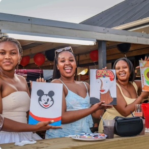 Ladies proudly showing their artwork