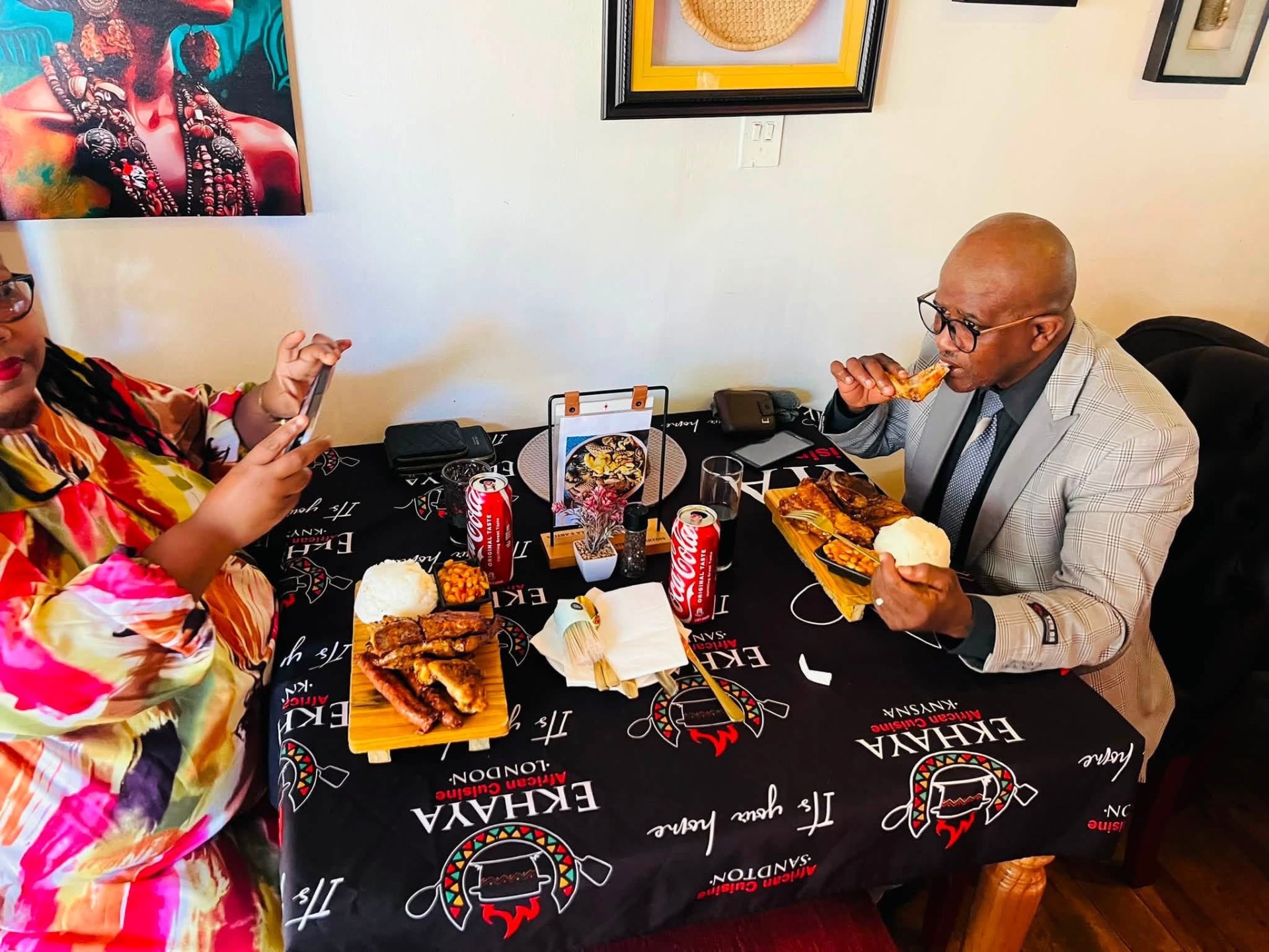 Couple sharing a braai platter with pap and chakalaka
